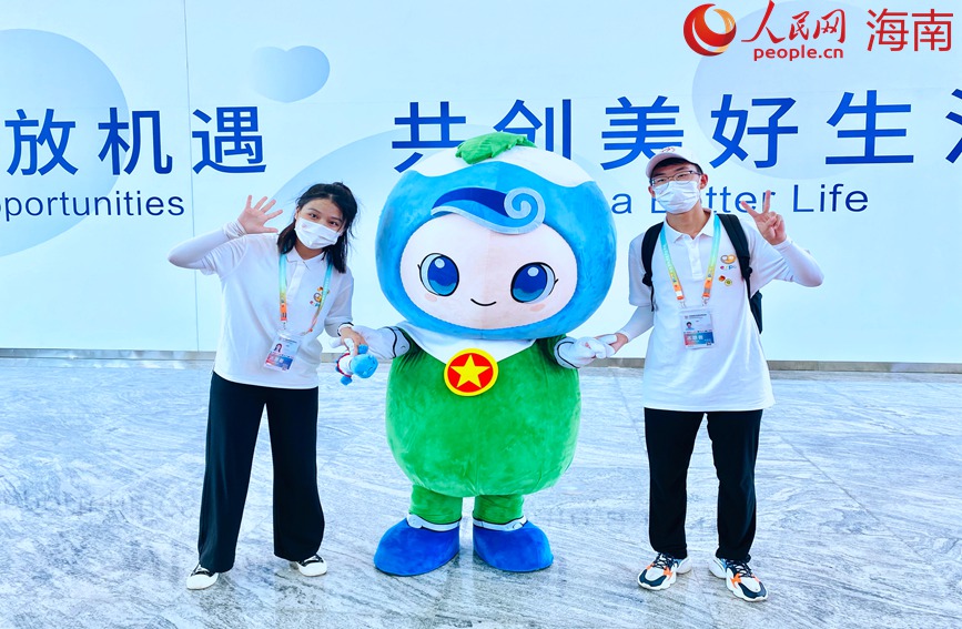 志愿者爭先與吉祥物合影。李浩蓉攝