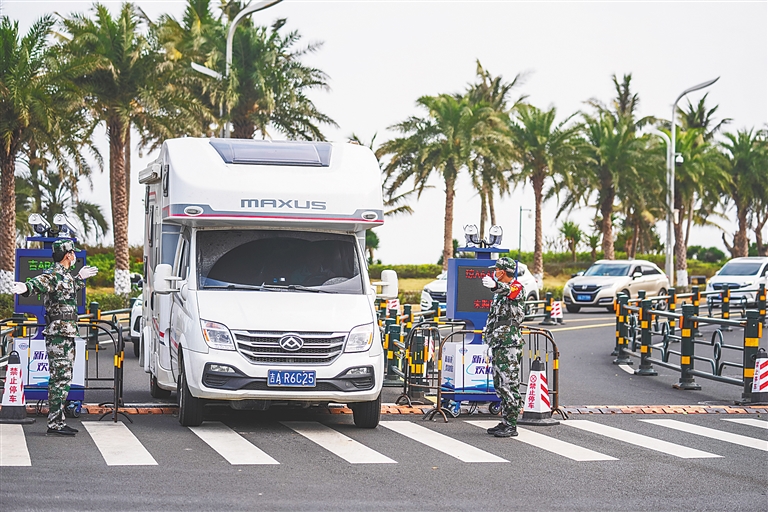 日前，在海口長濱北五路和長樂路交叉口的查驗點，工作人員引導車輛通過。海南日報全媒體記者 李天平 攝